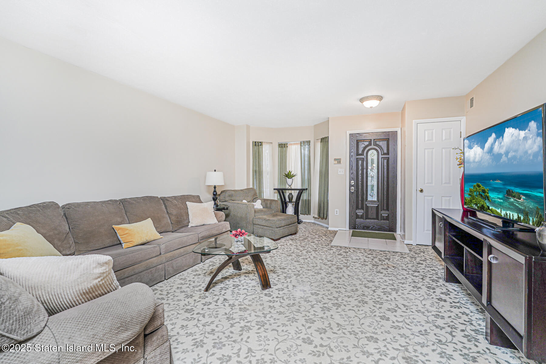342 Chelsea Street Staten Island, NY 10307 - Photo 3 of 35 a living room with furniture and a flat screen tv