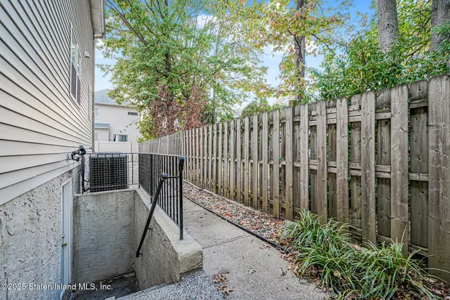 a white house that has tree in front of it