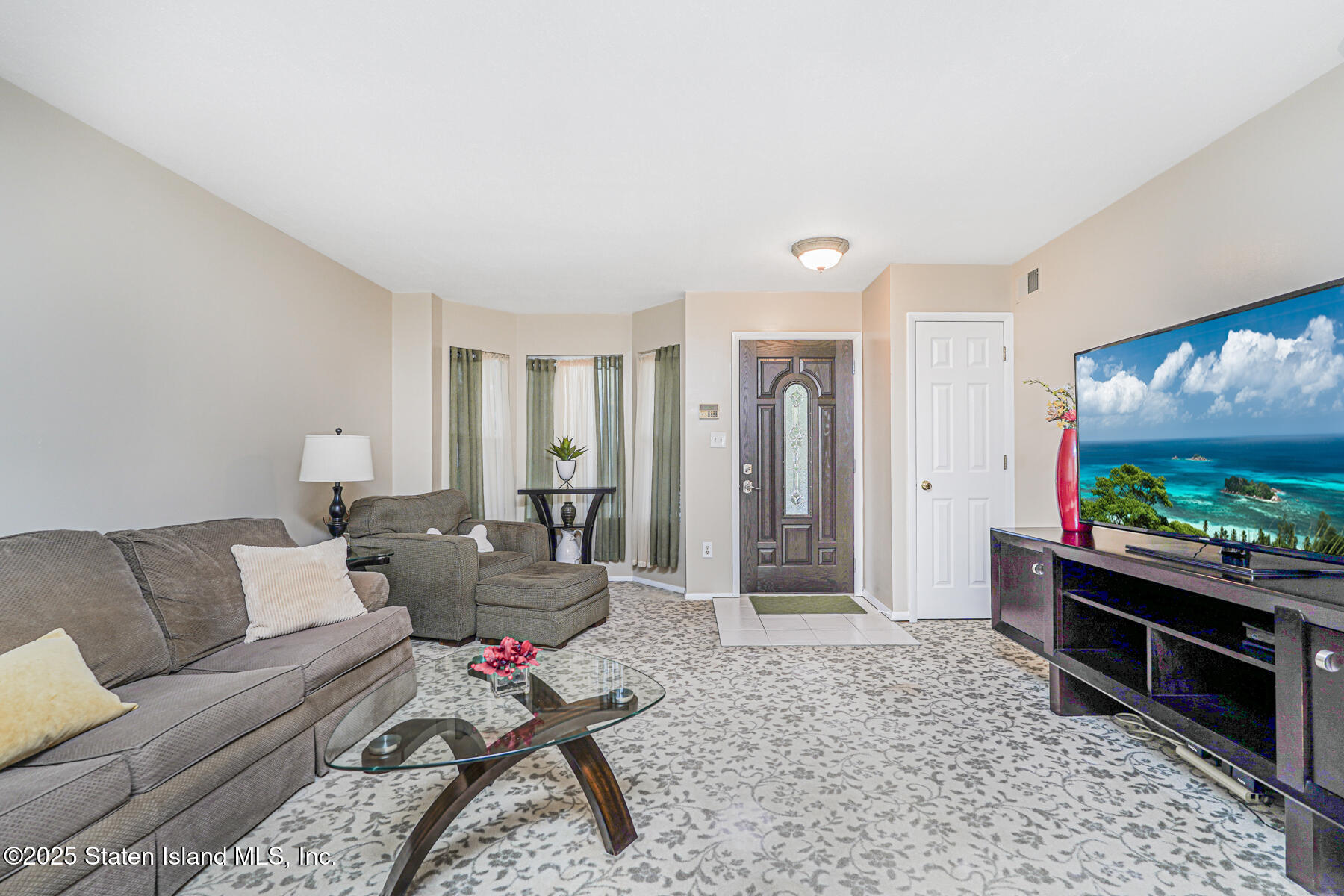 342 Chelsea Street Staten Island, NY 10307 - Photo 5 of 35 a living room with furniture and a flat screen tv