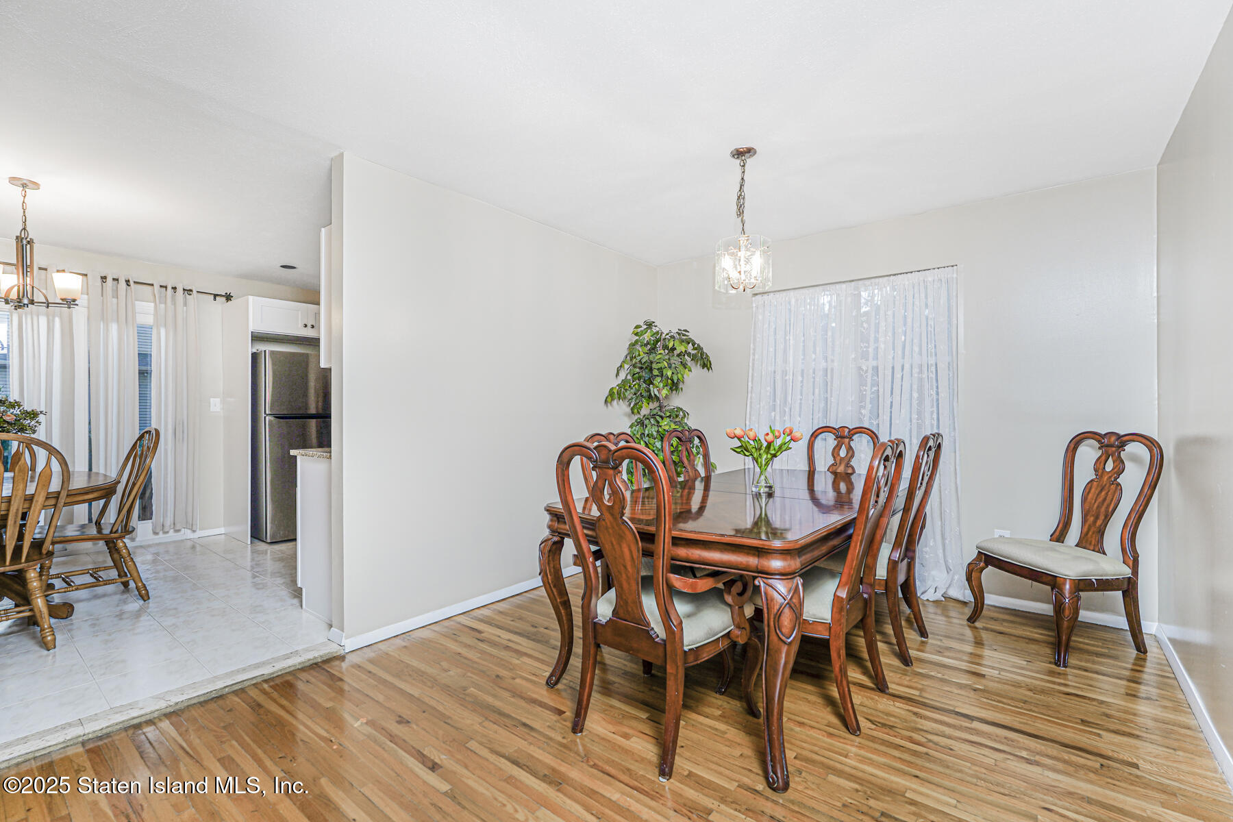 342 Chelsea Street Staten Island, NY 10307 - Photo 8 of 35 a dining room with furniture a chandelier and wooden floor