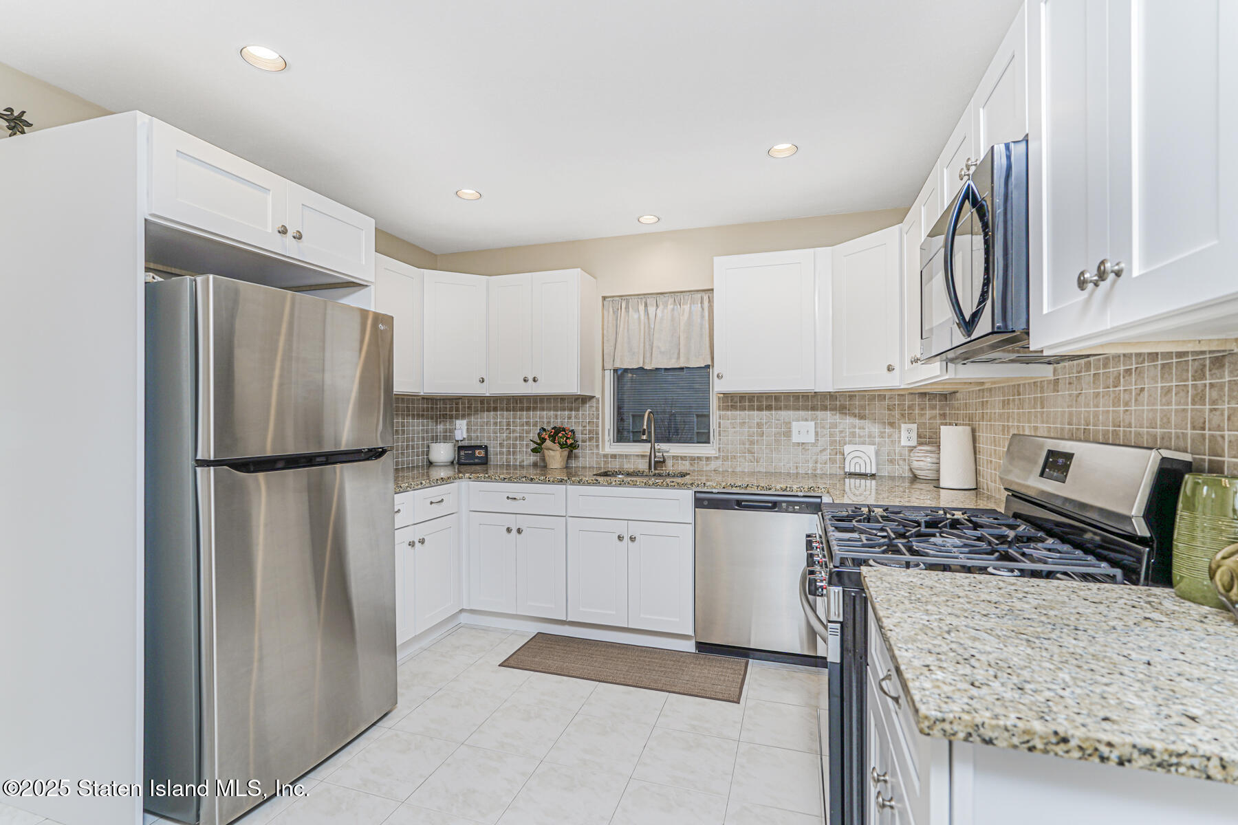342 Chelsea Street Staten Island, NY 10307 - Photo 10 of 35 a kitchen with a refrigerator and a stove top oven