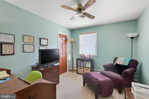a bedroom with furniture and a flat screen tv