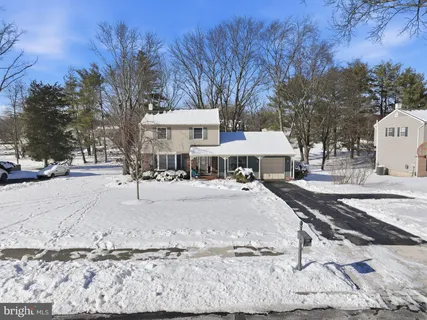 a view of a patio with a table and chairs under an umbrella