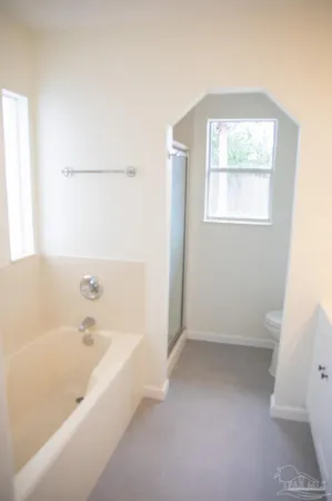 a bathroom with a bathtub and a window