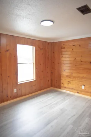 an empty room with a empty space and a window