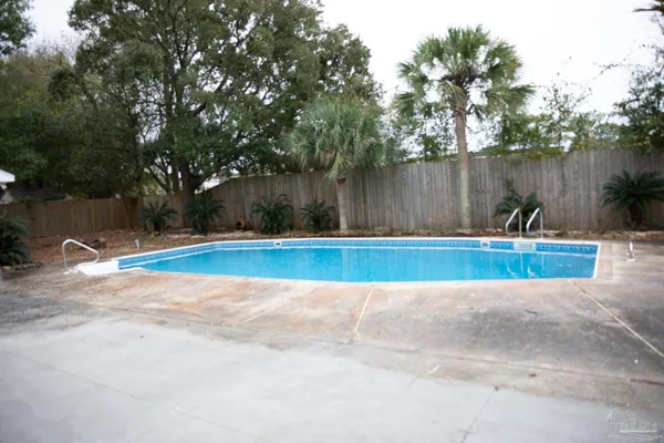 a view of a swimming pool with a yard