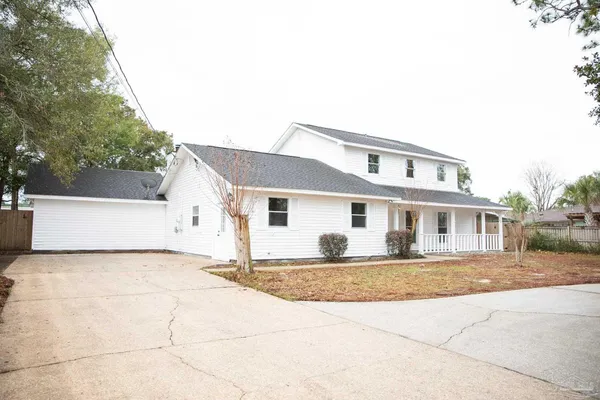 a house that has a tree in front of it