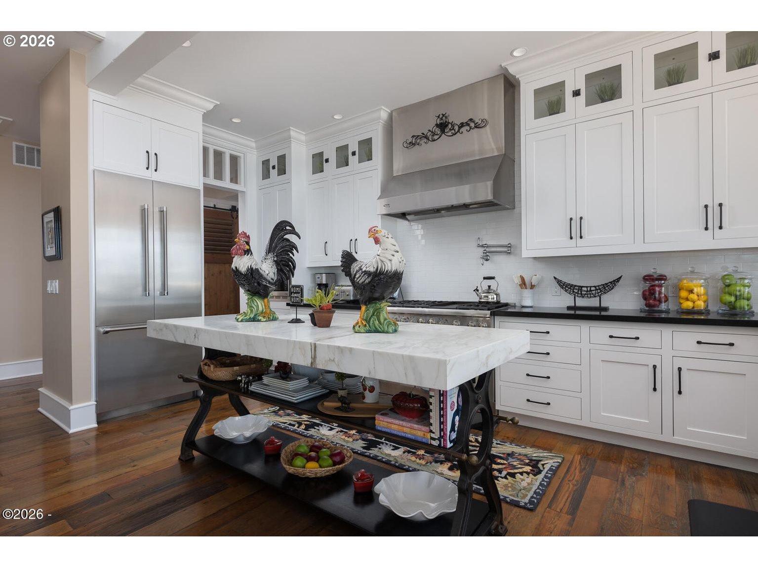 520 Cove Point Depoe Bay, OR 97341 - Photo 11 of 43 a kitchen with stainless steel appliances granite countertop a table chairs in it and white cabinets