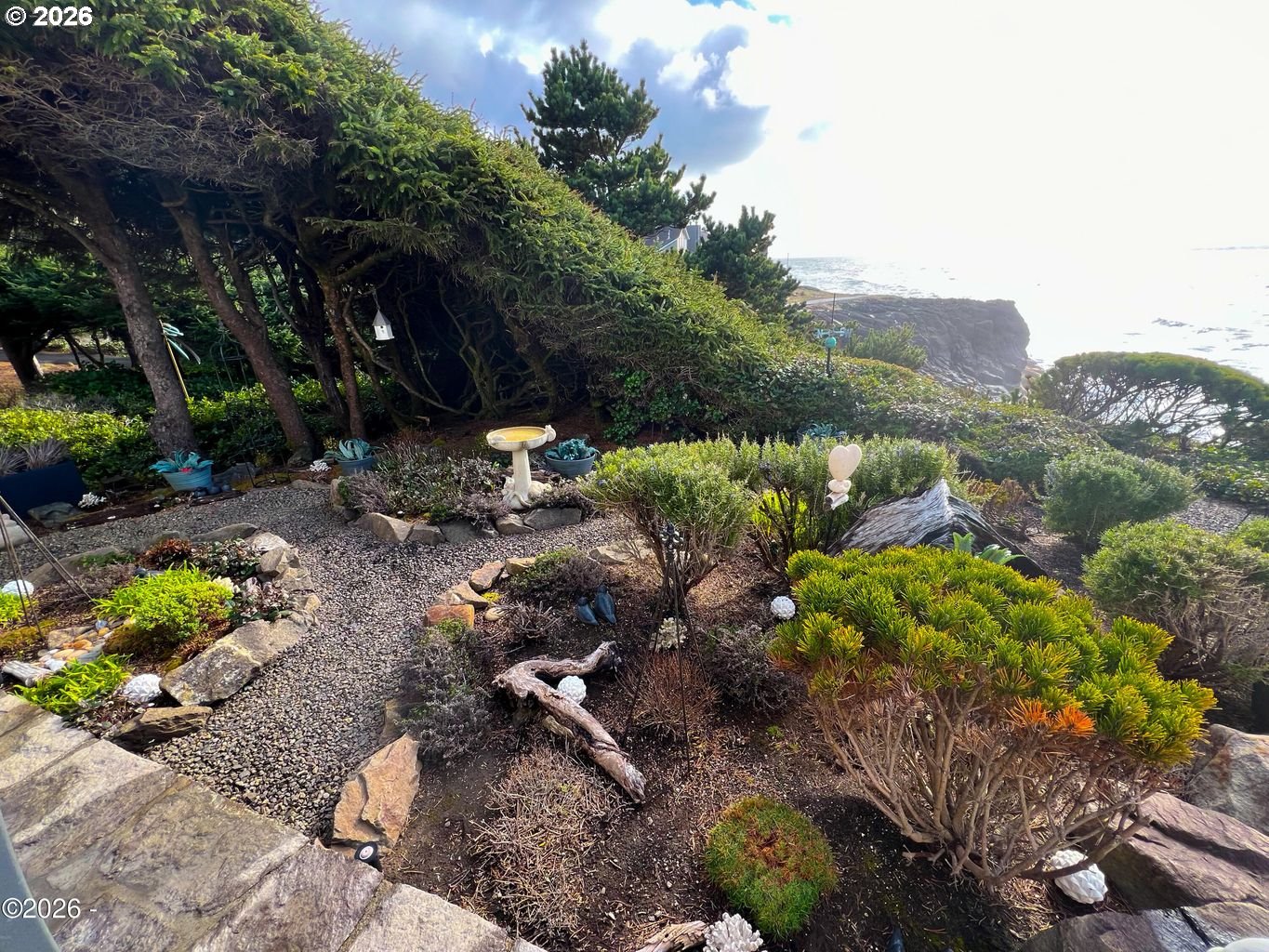 520 Cove Point Depoe Bay, OR 97341 - Photo 33 of 43 a backyard of a house with a yard and outdoor seating