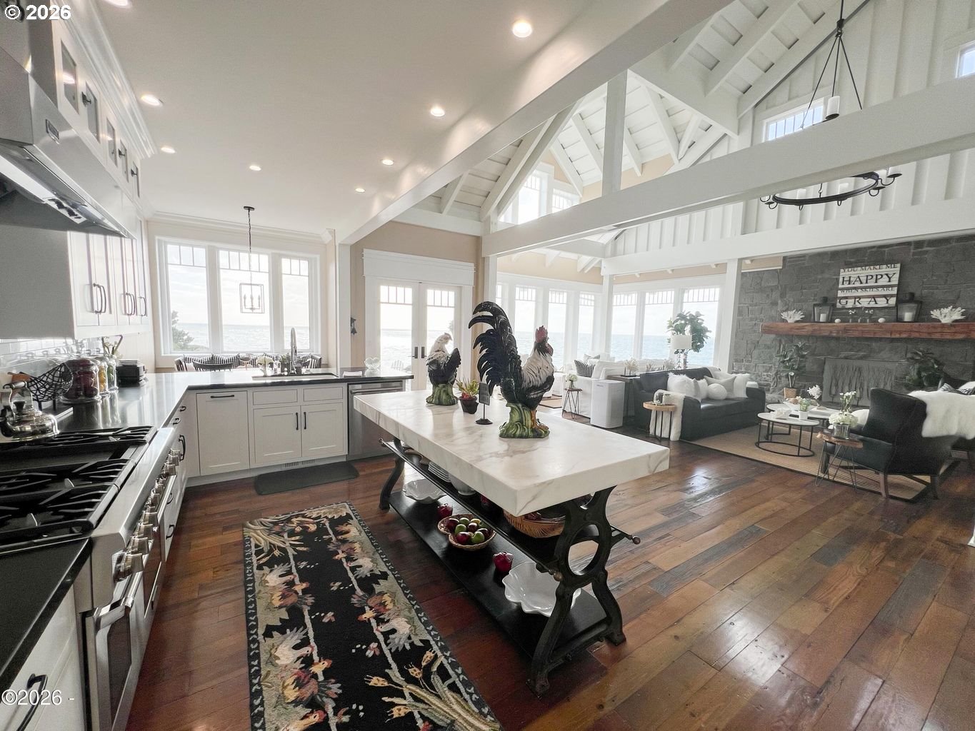 520 Cove Point Depoe Bay, OR 97341 - Photo 8 of 43 a kitchen with stainless steel appliances granite countertop a stove top oven a sink counter space and living room view