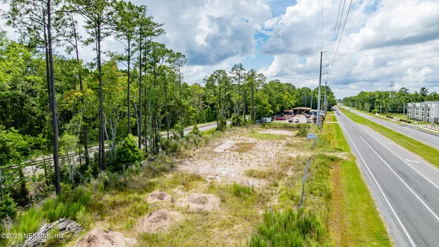 a view of swimming pool with a yard and large trees