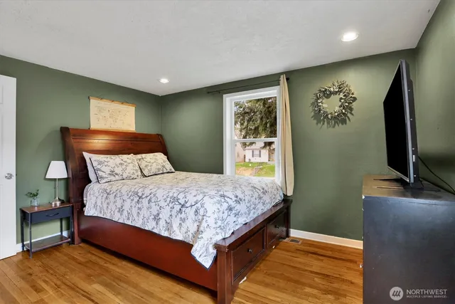 a bedroom with a bed and a flat screen tv