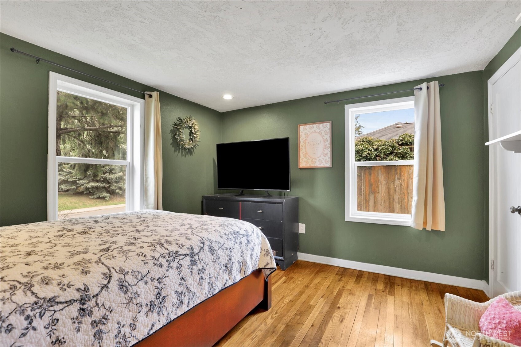 2819 West Olympic Avenue Spokane, WA 99205 - Photo 12 of 40 a bedroom with a bed and a flat screen tv