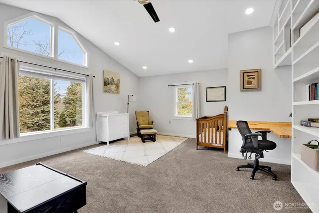 a view of a livingroom with workspace and a window