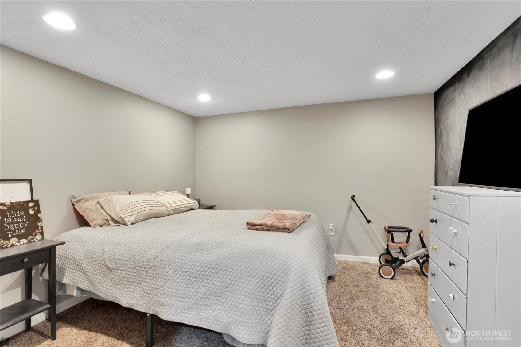 2819 West Olympic Avenue Spokane, WA 99205 - Photo 24 of 40 a bedroom with a bed and a flat screen tv