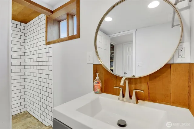 a bathroom with a sink and a mirror