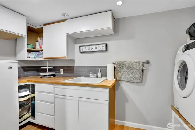 a room with a sink and a washer dryer