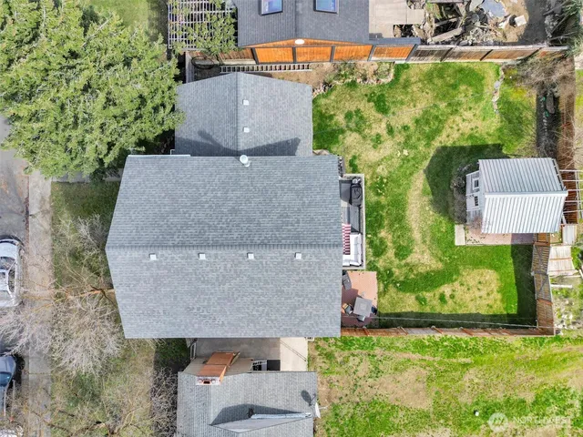 an aerial view of a house with a yard