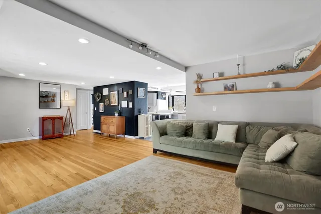 a living room with furniture and a wooden floor