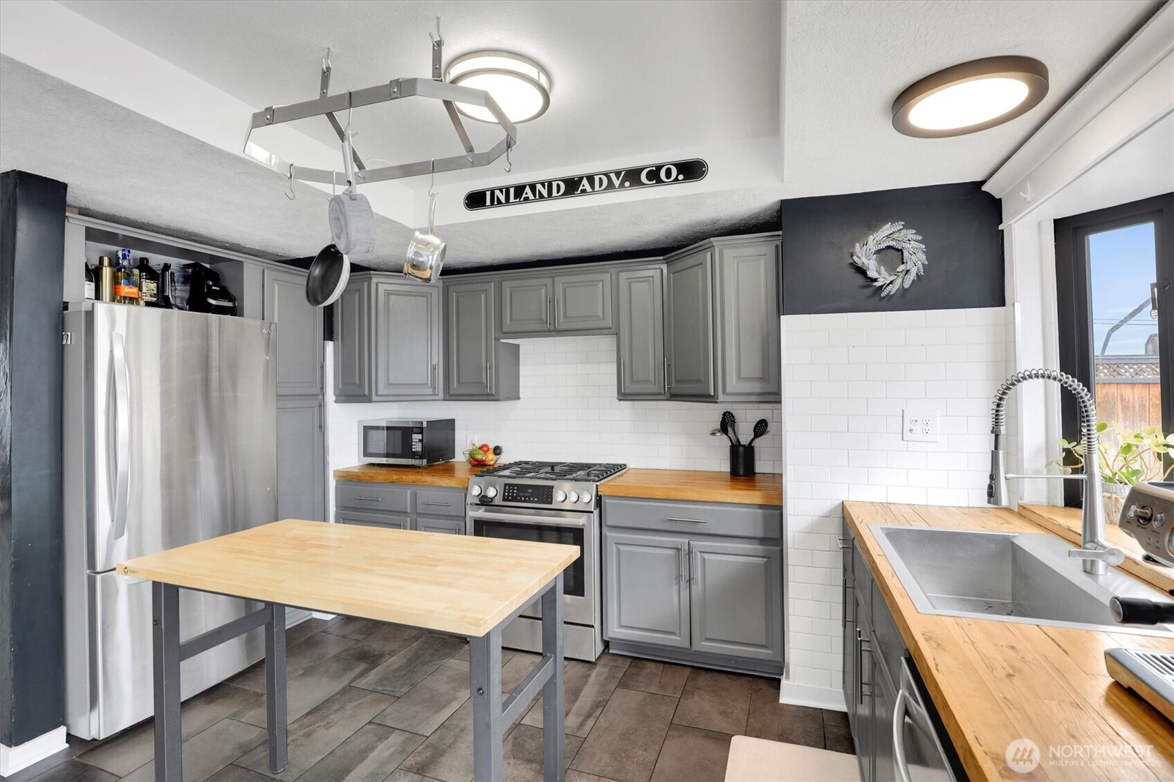 2819 West Olympic Avenue Spokane, WA 99205 - Photo 6 of 40 a kitchen with a sink a stove and chairs