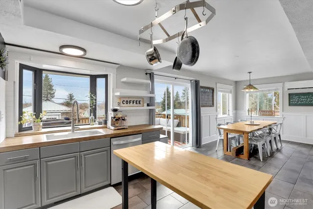 a kitchen with a table chairs and wooden floor