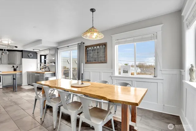 a dining room with furniture a chandelier and wooden floor