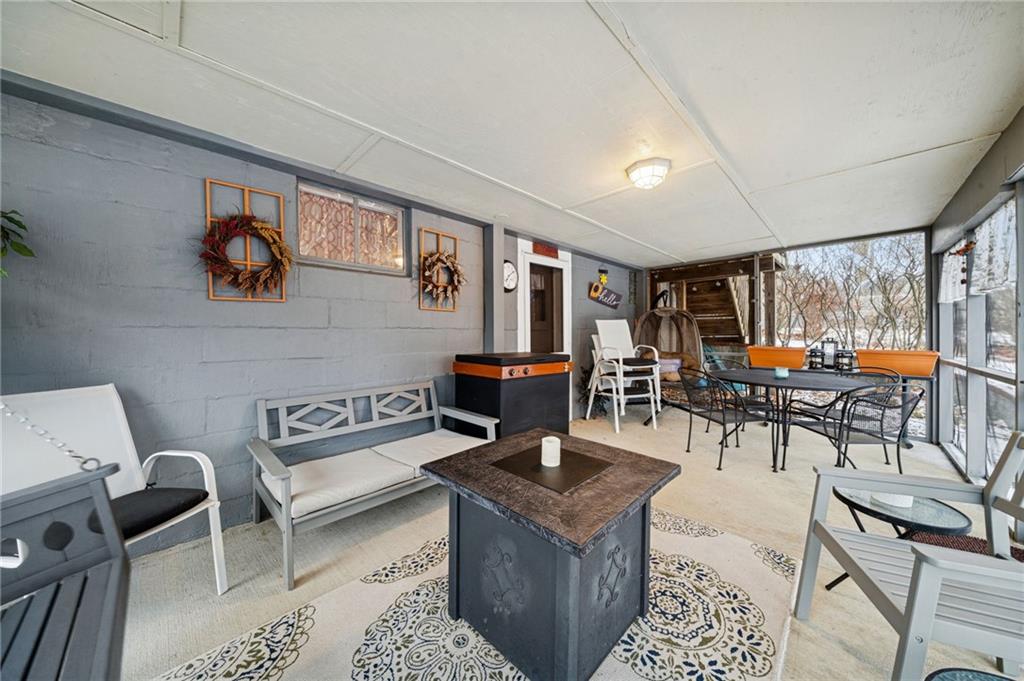 31 Locust Lane Pittsburgh, PA 15241 - Photo 28 of 35 a living room with furniture and a dining table with projector the view