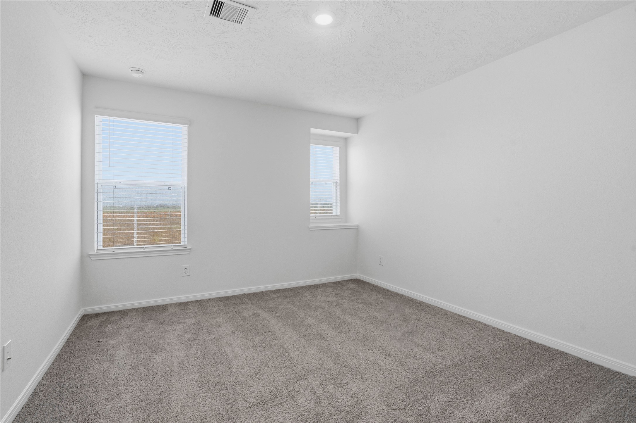 2503 Spruce Hl Road Beasley, TX 77417 - Photo 22 of 31 Well appointed secondary bedroom that features plush carpeting, neutral paint tones, recessed lighting, large window, and a generously sized closet.