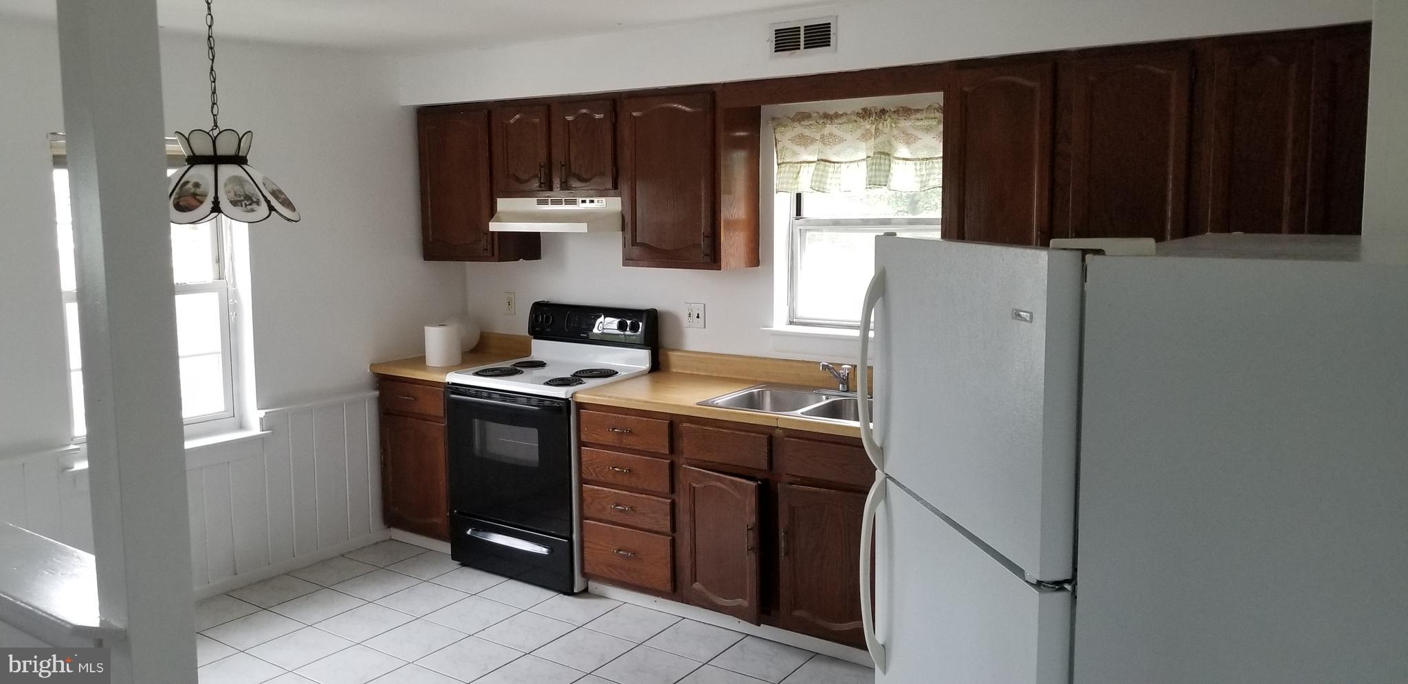 581 Fish Pond Road, Unit UP Glassboro, NJ 08028 - Photo 4 of 10 a room with a window and a refrigerator