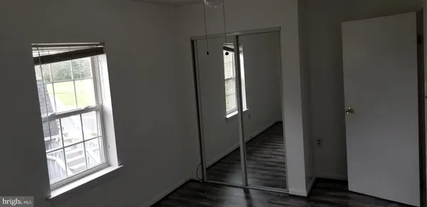 a view of a hallway with windows and stairs