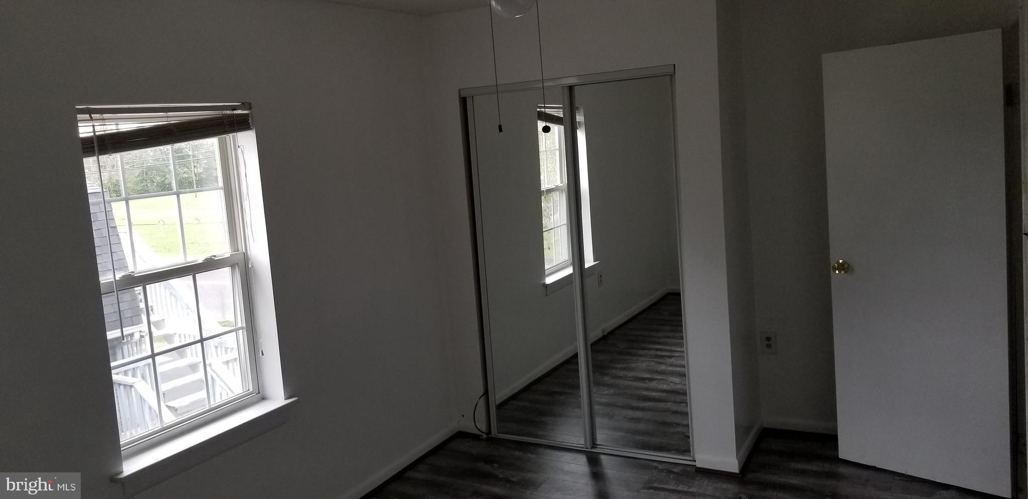 581 Fish Pond Road, Unit UP Glassboro, NJ 08028 - Photo 7 of 10 a view of a hallway with windows and stairs