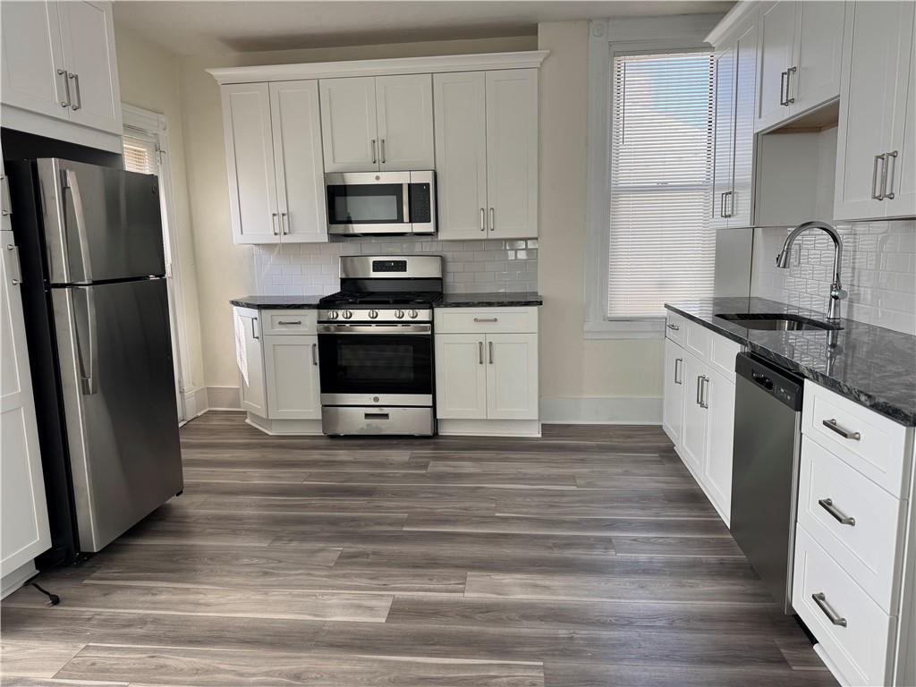94 South 18th Street, Unit 2 Pittsburgh, PA 15203 - Photo 11 of 20 a kitchen with granite countertop a refrigerator stove and sink