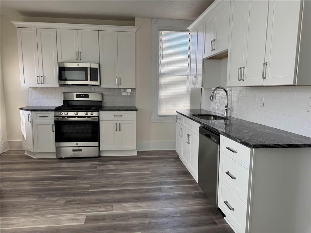 94 South 18th Street, Unit 2 Pittsburgh, PA 15203 - Photo 10 of 20 a kitchen with stainless steel appliances granite countertop a stove and a microwave