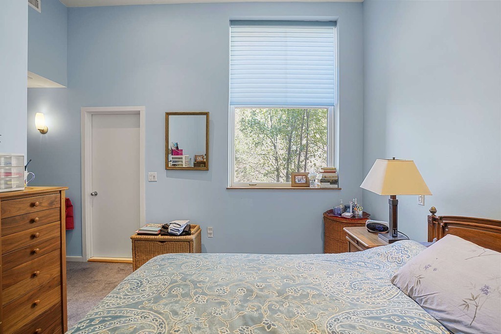 145 St Botolph Street, Unit 21 Boston, MA 02115 - Photo 17 of 23 a bedroom with a bed and a lamp on dresser