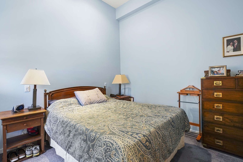 145 St Botolph Street, Unit 21 Boston, MA 02115 - Photo 18 of 23 a bedroom with a bed and a lamp on the dresser