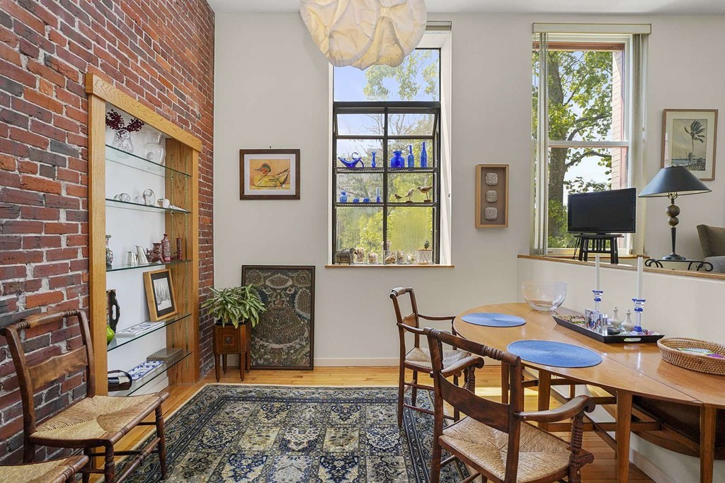 145 St Botolph Street, Unit 21 Boston, MA 02115 - Photo 6 of 23 a view of a dining room with furniture and a potted plant