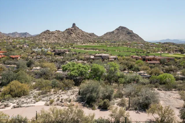 a view of a town with mountains in the background