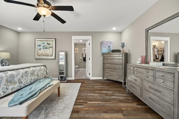 a spacious bedroom with a bed and a chandelier