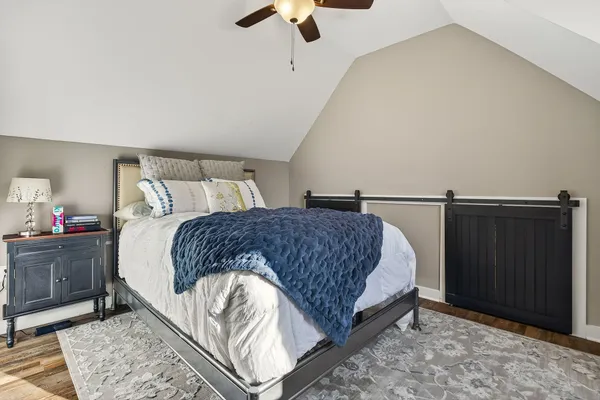 a bedroom with a bed and a chandelier