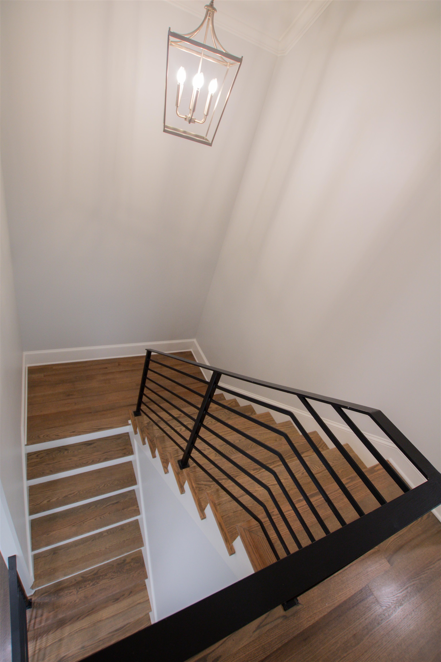 2611 Moore Road Germantown, TN 38138 - Photo 25 of 35 Stairs featuring ornamental molding, an inviting chandelier, and hardwood / wood-style flooring