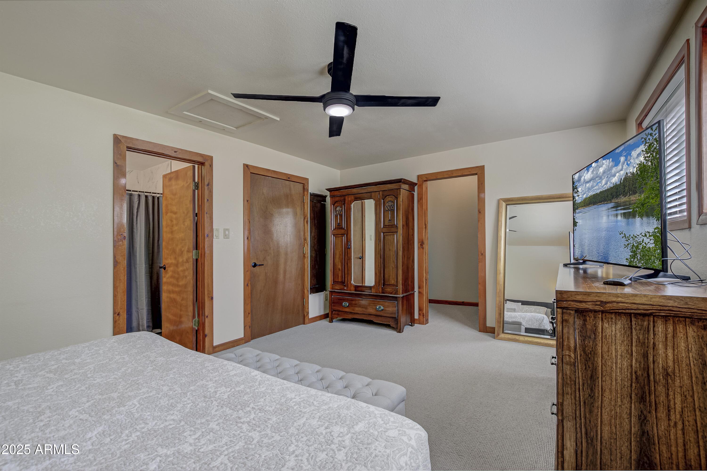 4763 Ernies Road Strawberry, AZ 85544 - Photo 11 of 50 a bedroom with a bed and a flat screen tv