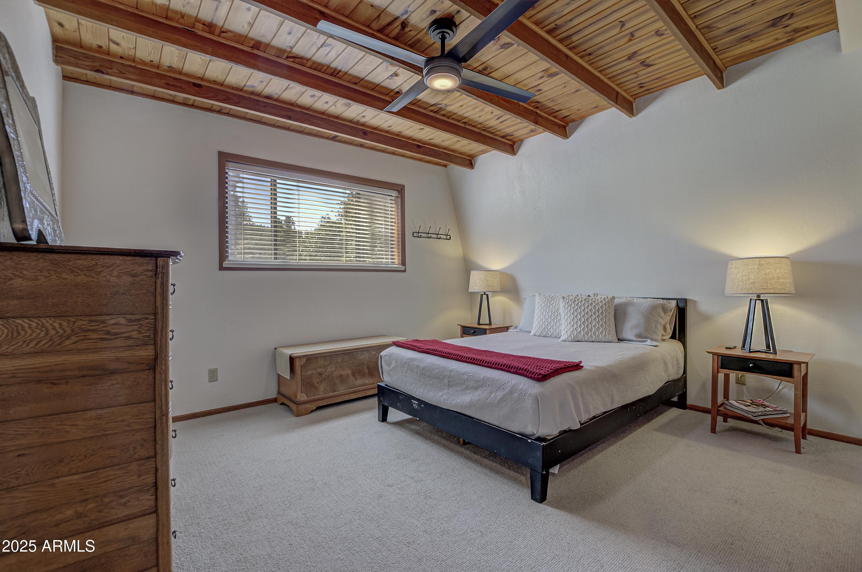 4763 Ernies Road Strawberry, AZ 85544 - Photo 14 of 50 a spacious bedroom with a bed and a chandelier