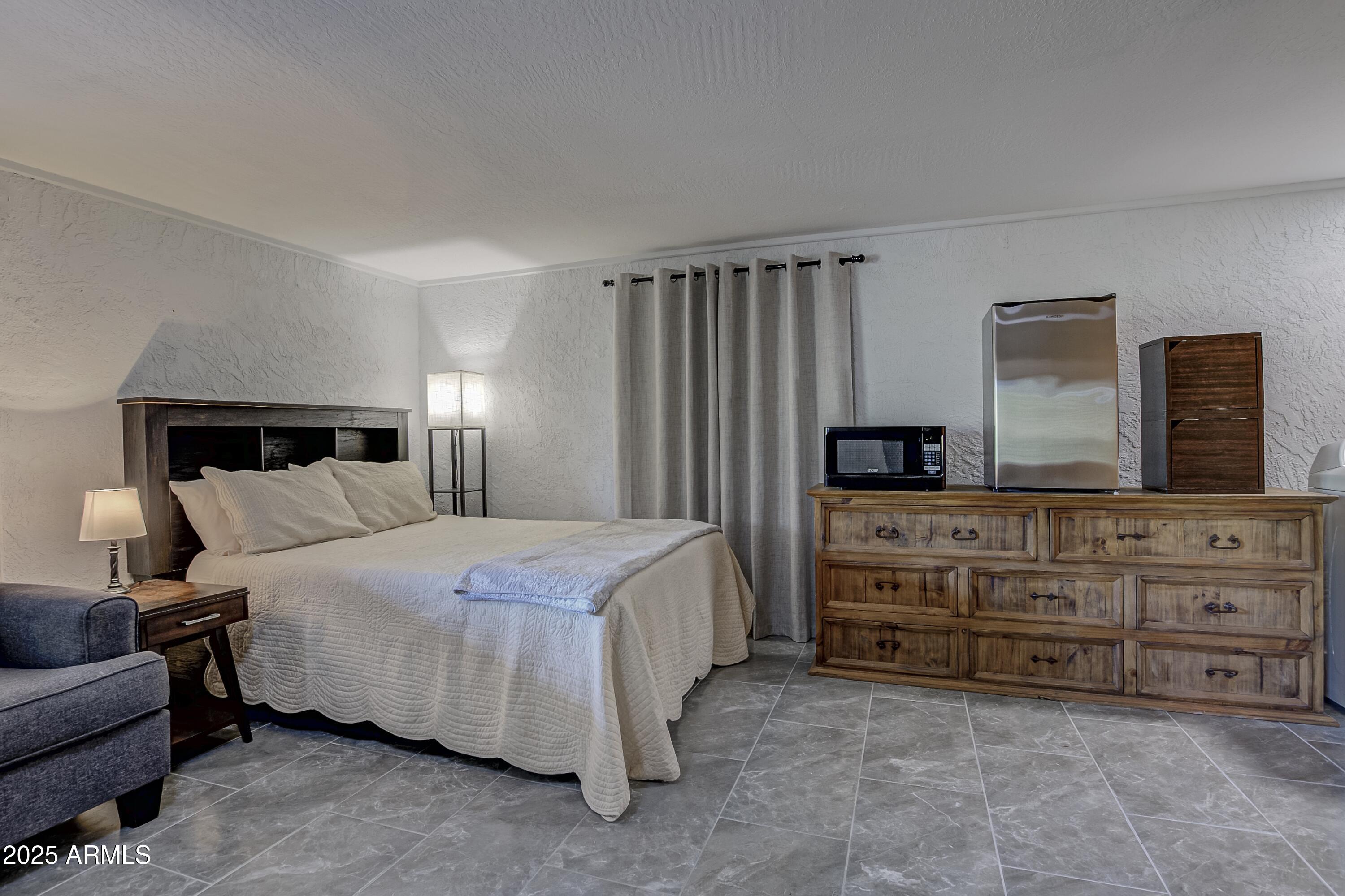 4763 Ernies Road Strawberry, AZ 85544 - Photo 25 of 50 a bedroom with a bed and a couch