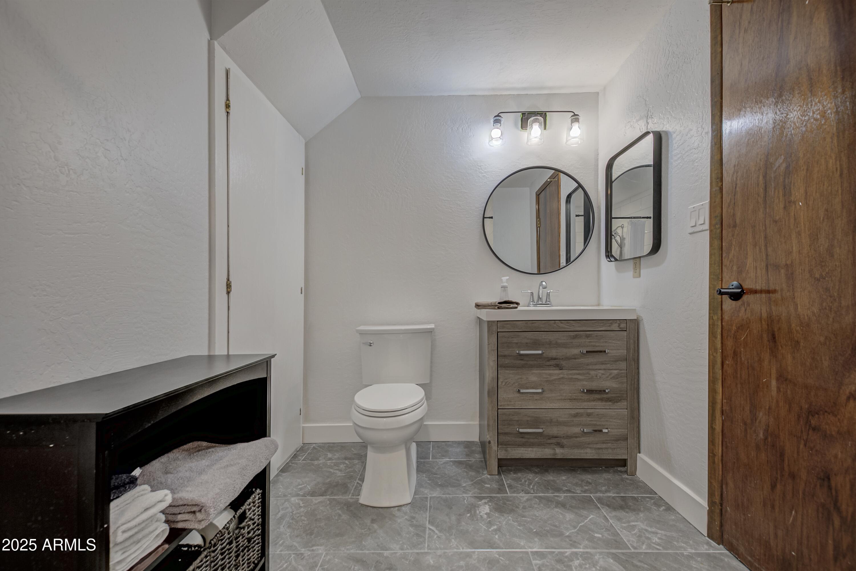 4763 Ernies Road Strawberry, AZ 85544 - Photo 28 of 50 a bathroom with a toilet a sink and mirror