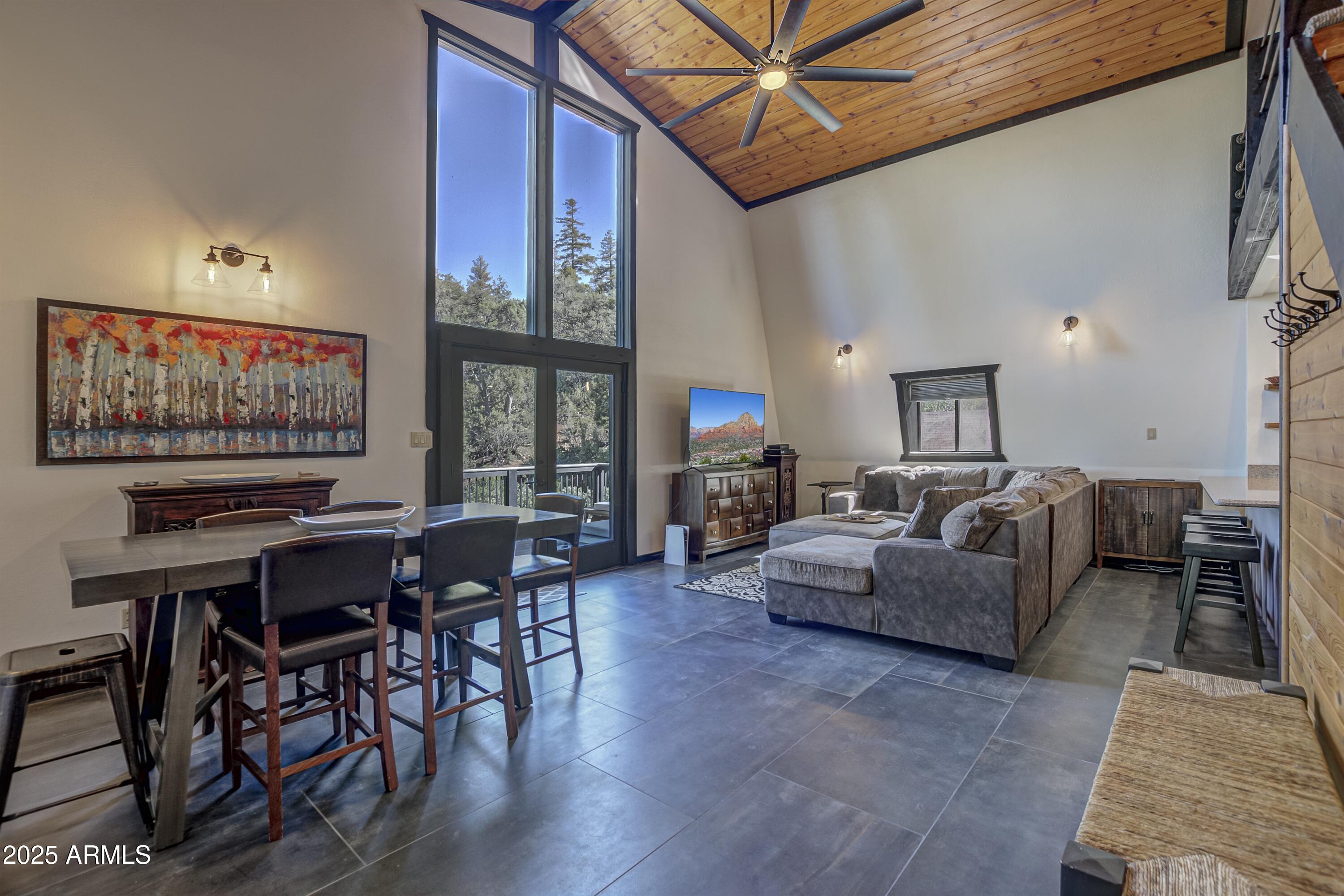 4763 Ernies Road Strawberry, AZ 85544 - Photo 3 of 50 a living room with furniture a large window and a flat screen tv