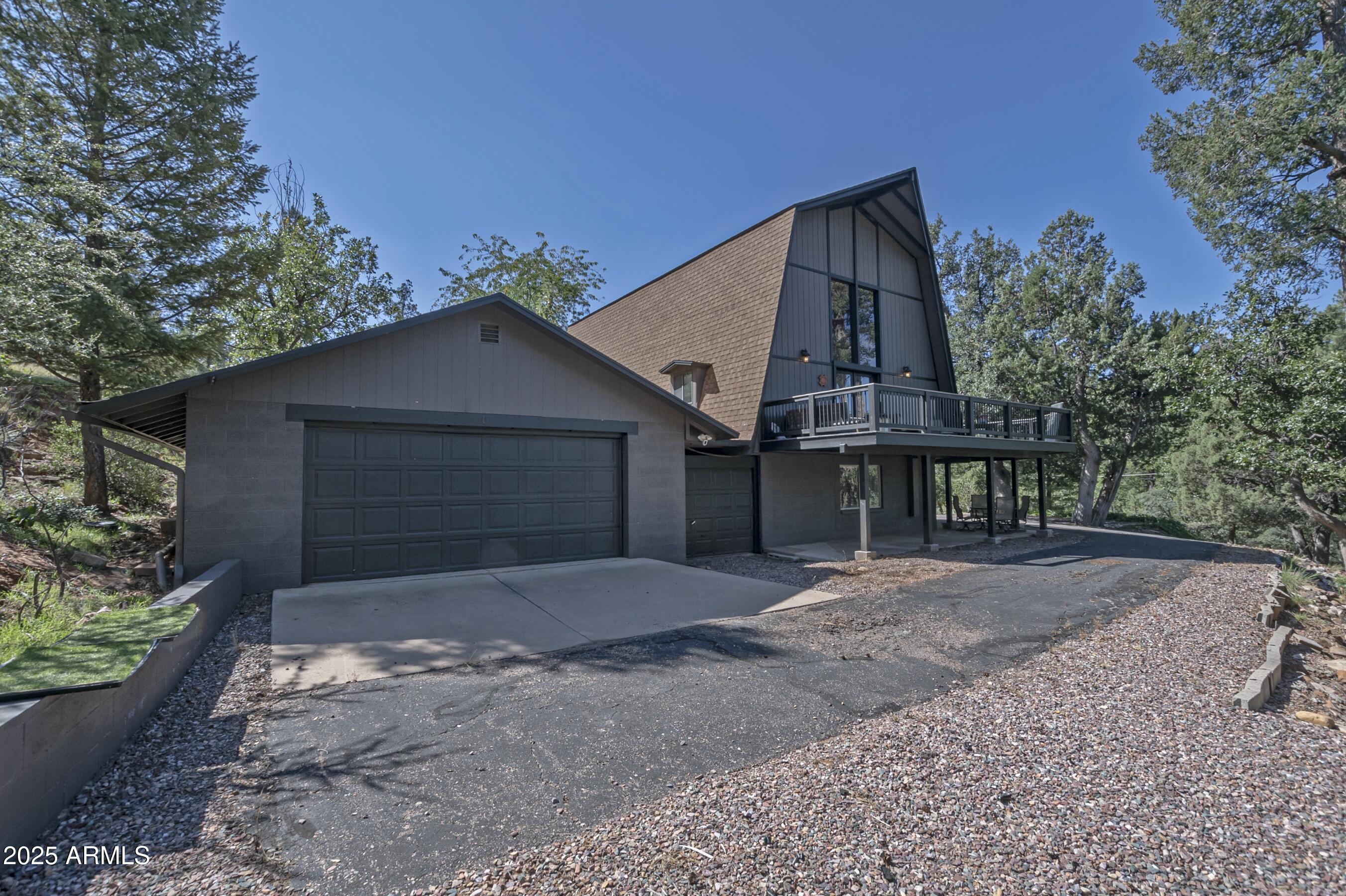 4763 Ernies Road Strawberry, AZ 85544 - Photo 43 of 50 a front view of a house with a yard and garage