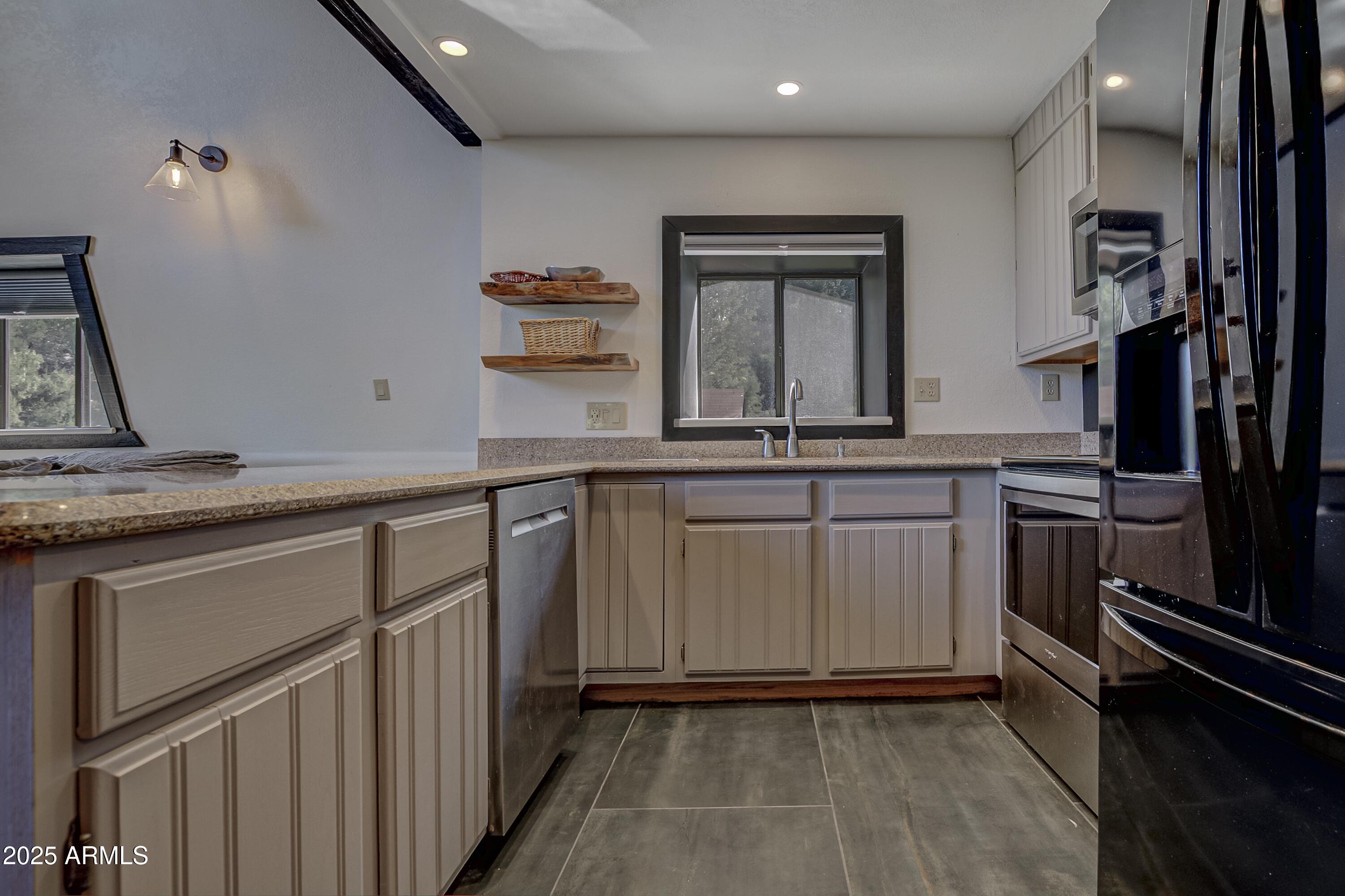 4763 Ernies Road Strawberry, AZ 85544 - Photo 9 of 50 a kitchen with white cabinets and appliances