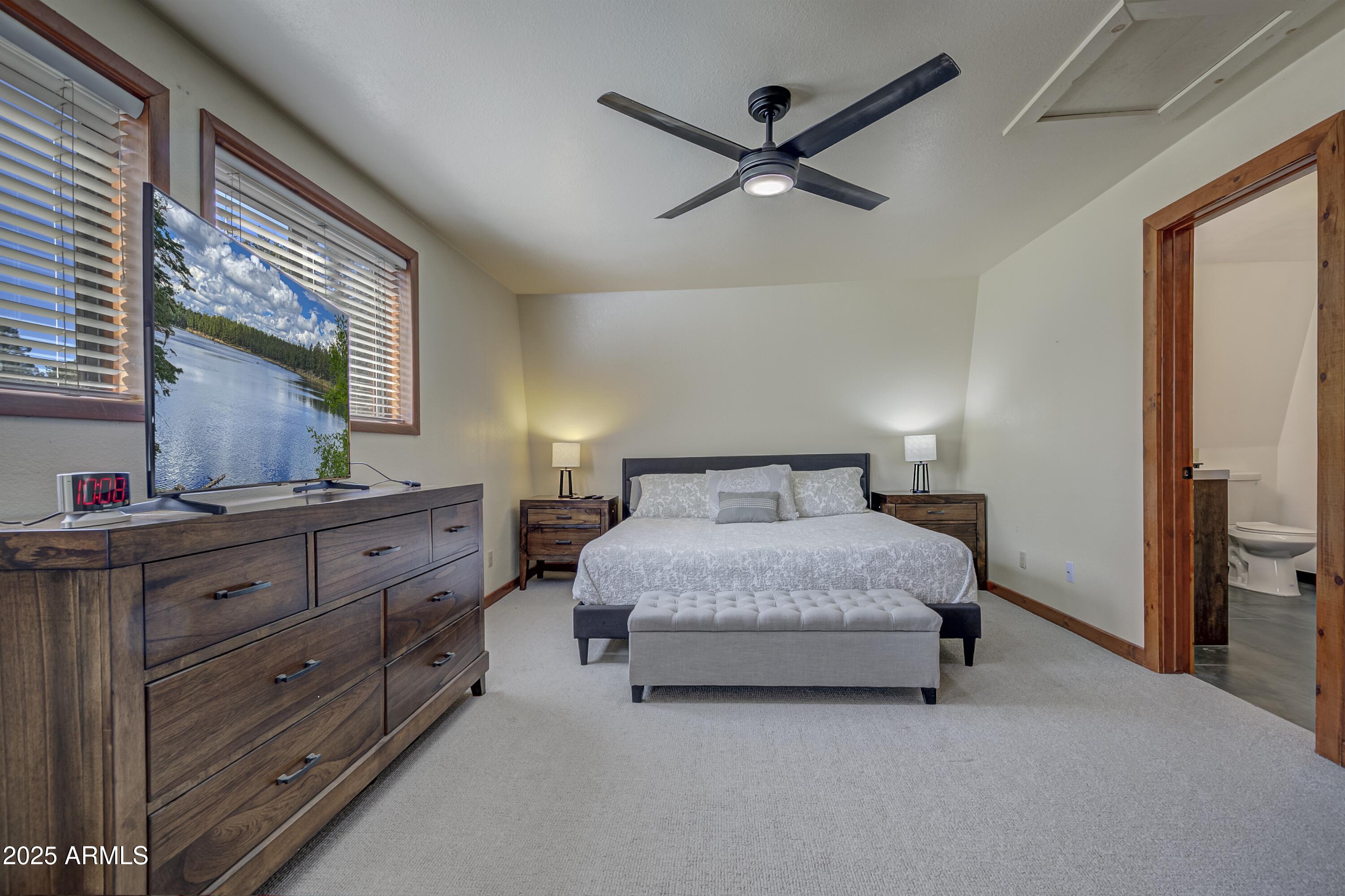 4763 Ernies Road Strawberry, AZ 85544 - Photo 10 of 50 a spacious bedroom with a bed and a dresser
