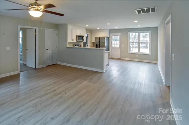 a view of a kitchen with wooden floor and a kitchen