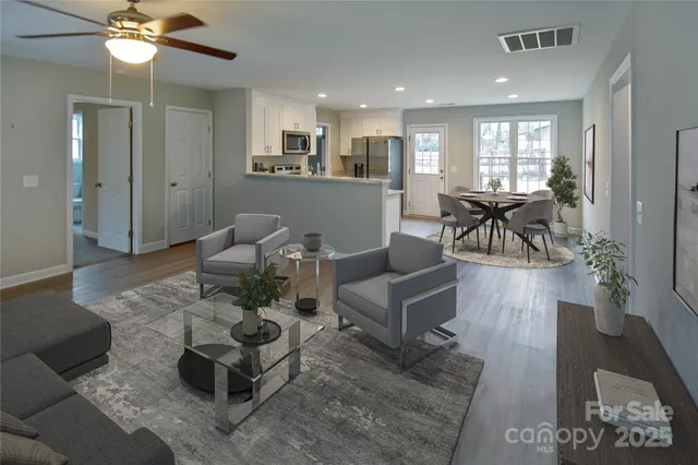 a living room with furniture and wooden floor